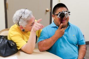 interpreter volunteer helping in vision area at a clinic